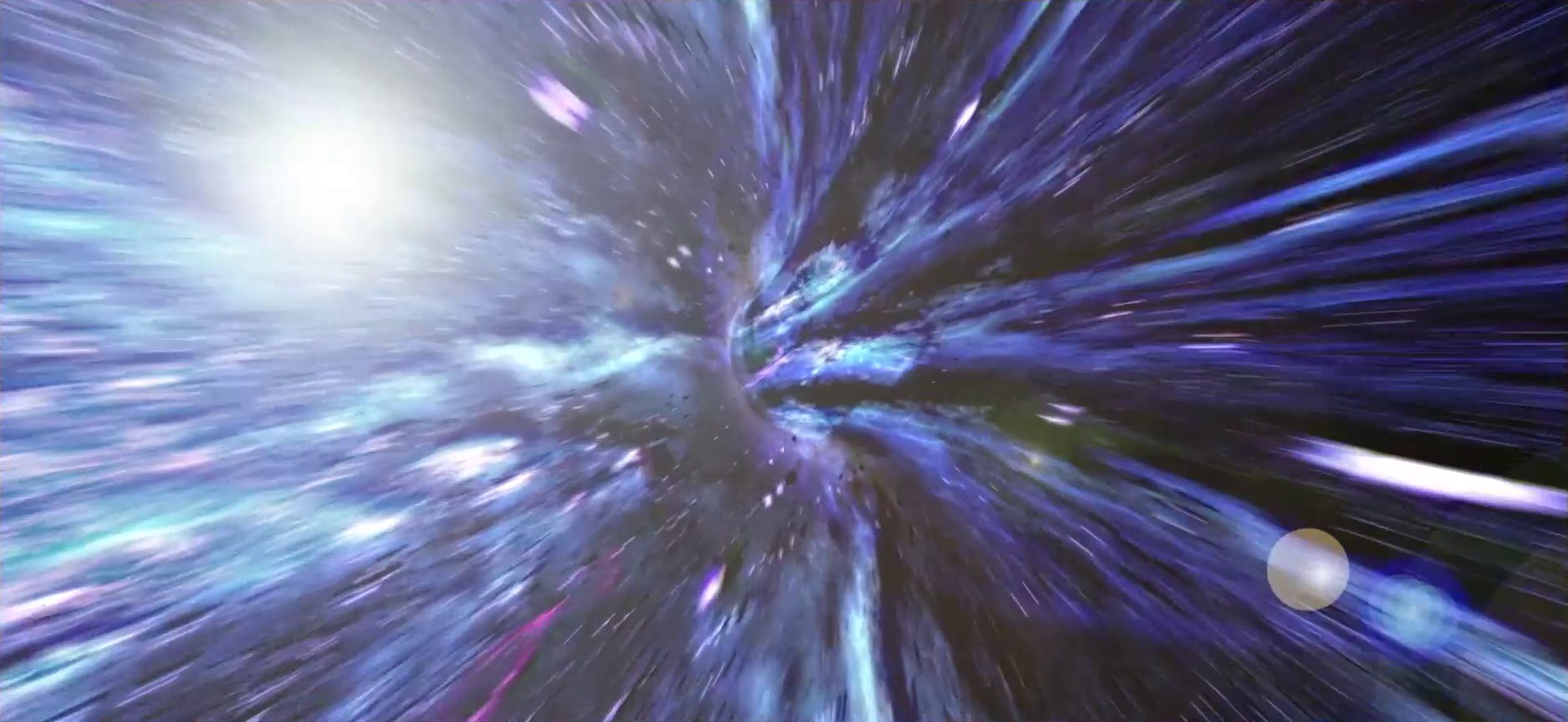 A visual effect of a time vortex similar to the one used in Doctor Who intro sequences. The camera is in a tunnel of purple, blue, and white light curving off into the distance. Our view is obscured when the tunnel turns a corner. A bright light can be seen through the left side of the tunnel, producing a lense flair in the lower right of the image.