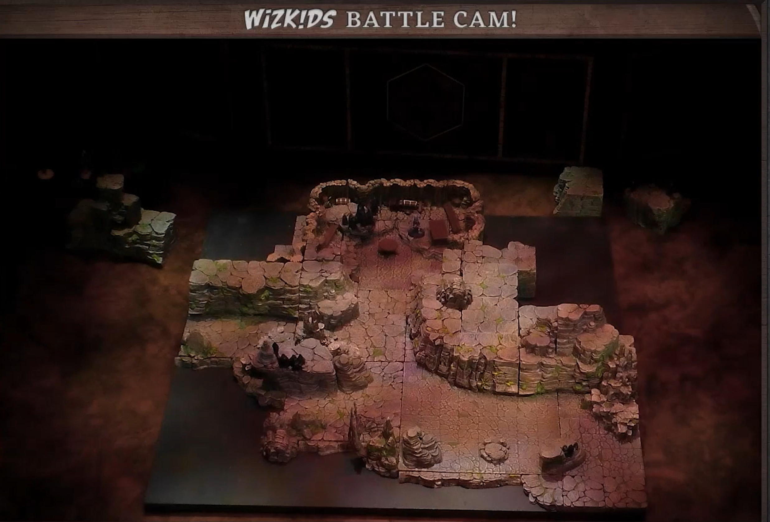A battlemap of rock-walled space dotted with rock formations and stalagmites. A token is in a chamber near the top.