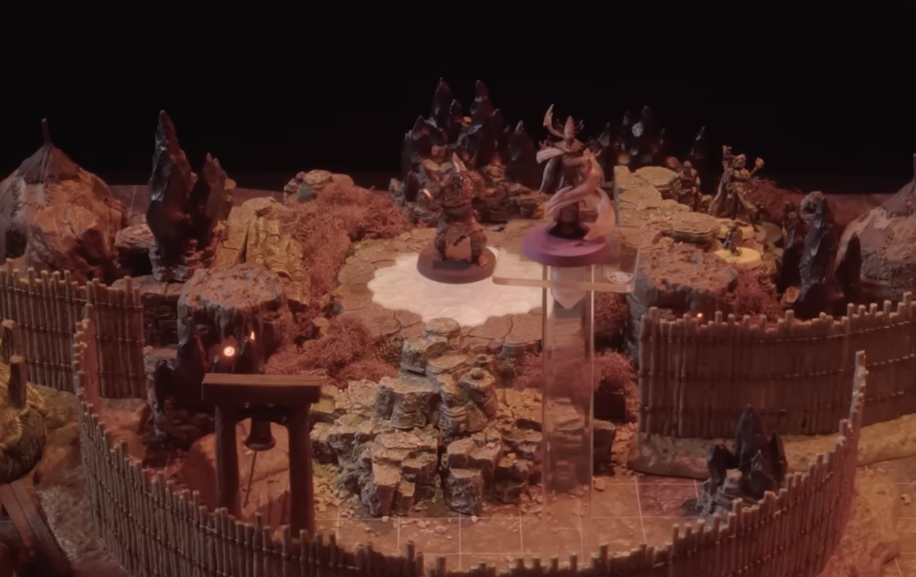 A battlemap of a fenced encampment built around a portal on the ground. A large Reiloran stands on the portal while another flies above in the foreground.