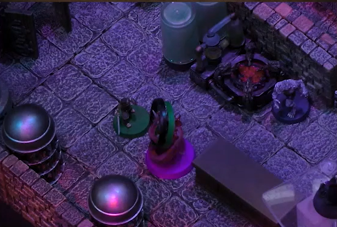 Orym facing off against a Reiloran Mystic surrounded by a purple swirl with a green and black ring on it. Chetney in wolf form stands aganist a nearby wall next to a forge.