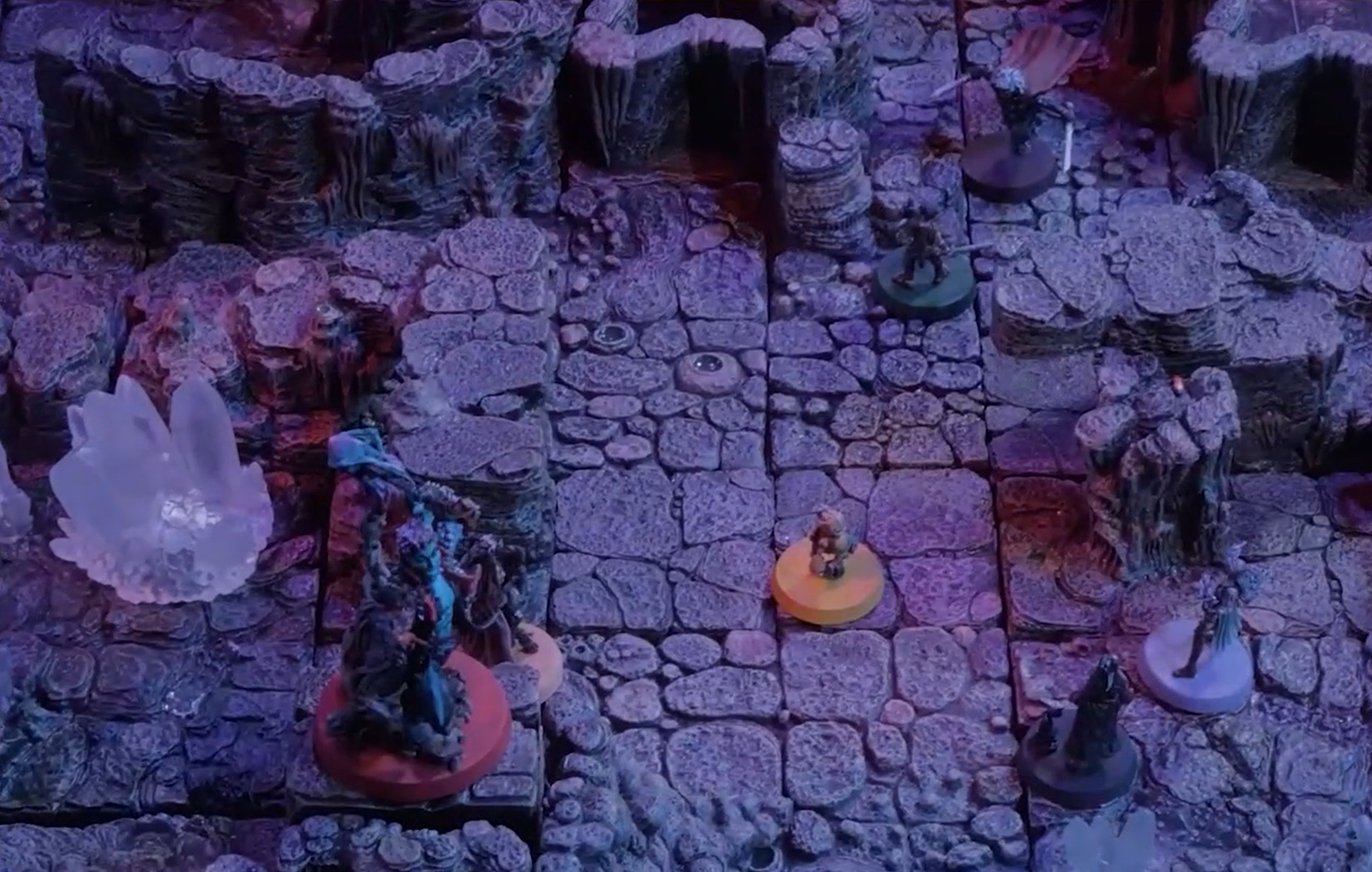 A battlemap of a cave chamber scattered with collections of cloudy white crystals. Ashton, Imogen, Laudna, Orym, Fearne, and FCG are standing in frame, with Otohan facing Orym.