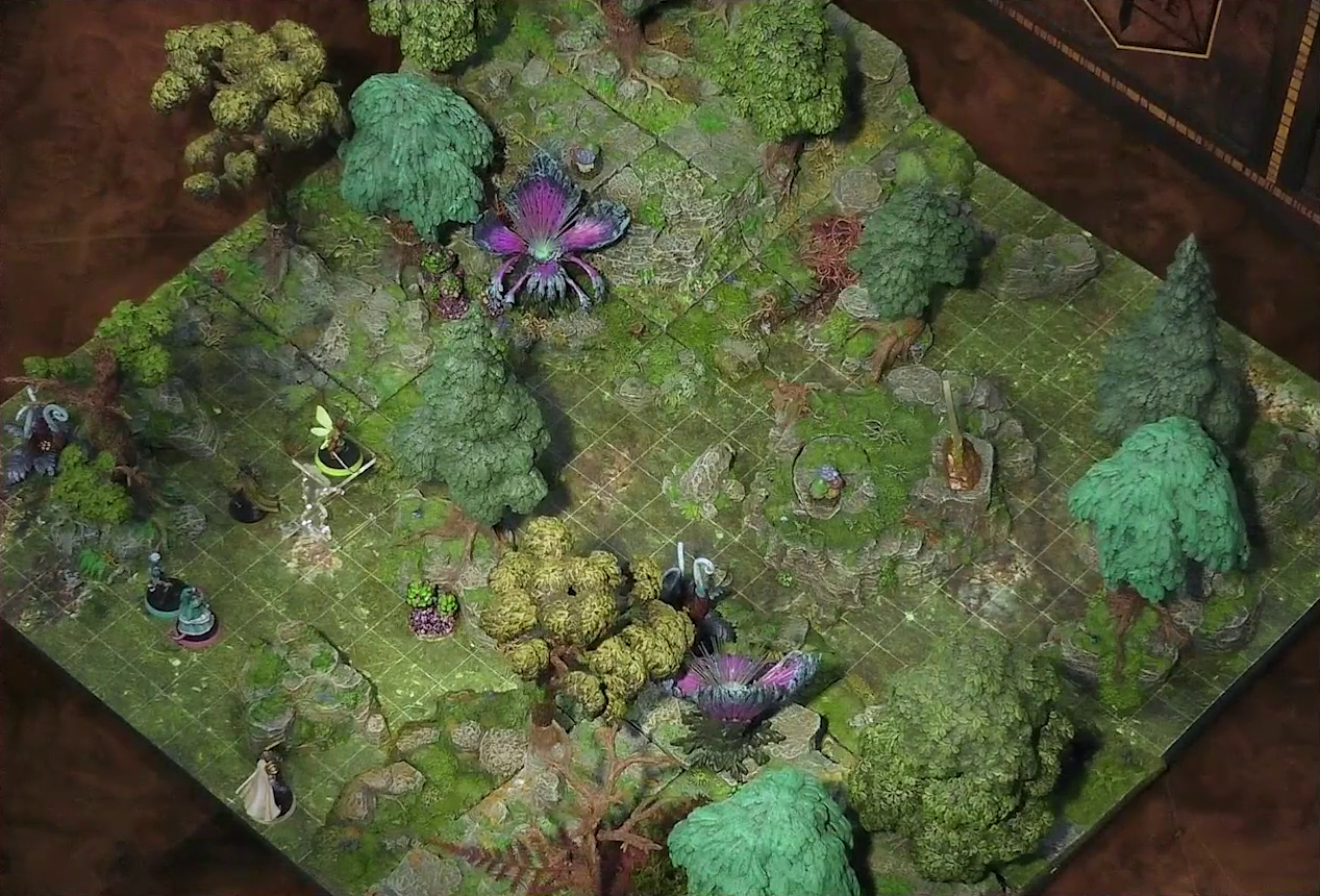 A battlemap of a forested glade with a variety of trees, mushrooms, and fey-like, purple plants. Thimble flies 10 feet in the air near a tree with Kattigan below her, while Wicander and Tyranny stand next to each other nearby. Teor stands just behind a nearby rocky outcropping. Two large purple flowers with four petals sit about fifty feet apart. A standing stone sits on a rocky platform near the glade’s center. In one corner of the glade is another raised rocky outcropping.