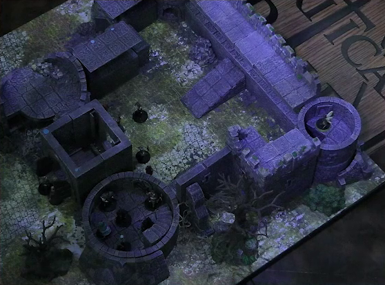 A battlemap of a ruined stone castle with sparse dead trees around its edges. The walled courtyard has a tower at each corner. The bottom-left tower has collapsed. Thimble stands in the top-right tower. Tyranny stands in the bottom right tower with other individuals. A few people are in the courtyard. Two guards stand in front of the wooden entry door into the courtyard. Five white horses stand out front and a few other individuals stand nearby.