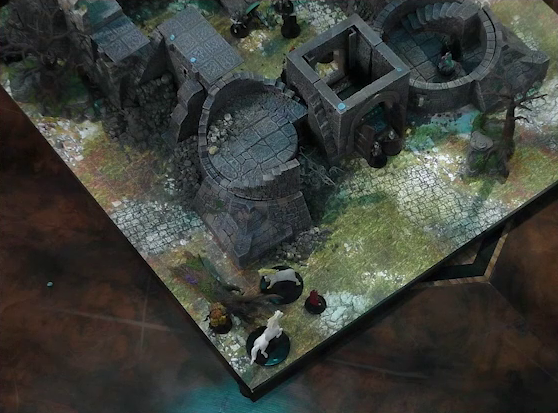 A battlemap of a ruined stone castle with sparse dead trees around its edges. Two white horses stand in front of a collapsed tower. Two guards stand in front of the open wooden entry door into the courtyard. Tyranny stands with Casimir in the tower to the right of the entrance. Inside the courtyard are some armored individuals standing over a fallen Wicander.