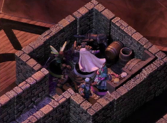 A battlemap of a stone dungeon focused on a small chamber containing Wicander, Tyranny, Wulferic, Kattigan, Teor, and Thimble. A narrow hallway leads into this chamber. Barrels sit against the walls of the chamber, some in shelves, some on the floor. One barrel stands on its end, the top open.