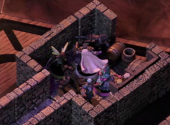 A battlemap of a stone dungeon focused on a small chamber containing Wicander, Tyranny, Wulferic, Kattigan, Teor, and Thimble. A narrow hallway leads into this chamber, and the wall opposite the entrance is missing as if it’s a doorway. Barrels sit against the walls of the chamber, some in shelves, some on the floor. One barrel stands on its end, the top open.