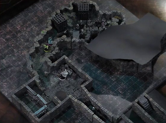 A battlemap of a stone dungeon. Wulferic, Wicander, and Kattigan stand single-file in a narrow hallway leading into a chamber. In that chamber, Teor stands in the corner with some wooden containers. Across the room are metal bars resembling an empty jail cell. Deeper into the dungeon is a naturally-formed chamber, where Thimble and Tyranny face off against a basilisk, a black-cloaked knight, and five armored guards with spears. Two large black cube-shaped cages are against one wall, and a stone slab with a coil of rope on it is against the opposite wall. The area deeper into the dungeon is obscured by black construction paper. Small glowing green dots and turquoise mushrooms are scattered across the floor and walls.