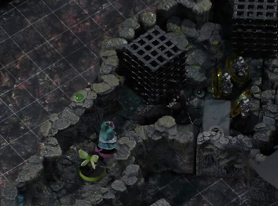 A battlemap of a naturally-formed small stone dungeon chamber. Thimble and Tyranny face off against a basilisk, a black-cloaked knight, and three armored guards. Two large black cube-shaped cages are against one wall, and a stone slab with a coil of rope on it is against the opposite wall. Small glowing green dots and turquoise mushrooms are scattered across the floor and walls.