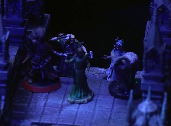 A battlemap of an ornate stone bridge focused on Thaisha, Aranessa, and Hala standing at one end. Behind them are an axe-wielding druid and Cruelty standing next to each other.