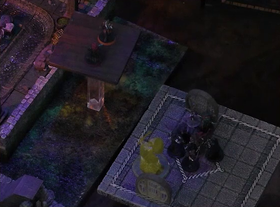 A battlemap of a stone underground area in the sewer focused on two raised platforms indicating multiple levels. Bolaire and Halandil stand on the higher one, while a knight made of light, Azune, Murray, Demodus Blix, and four Crow Keepers are on the lower one. A room with a sewer trench in it is just at the edge of the frame below both platforms.