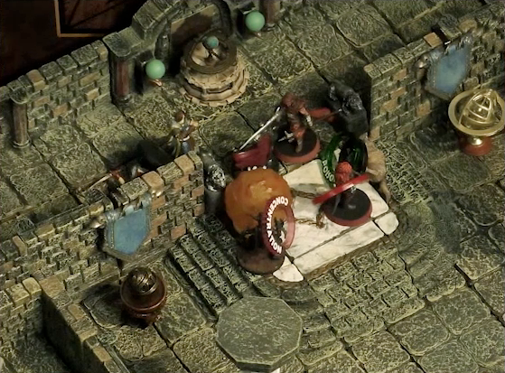 A battlemap of a large stone banquet chamber with surrounding hallways. Azune, Bolaire, and a Timmonish knight face off against two assassins entering the chamber through its north entrance. A Flaming Sphere floats among the assassins. A fallen Hound of the King with a “POISONED” status ring lays on the ground just inside the entrance. Bolaire has a red status ring around his miniature, and an assassin has a “CONCENTRATION” status ring.