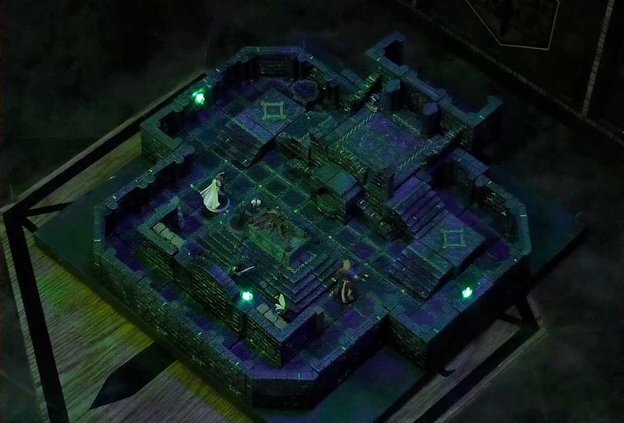 A battlemap of a stone chamber. A stone altar is in the center with a skeletal corpse on top of it, next to which stand Occtis and Pincushion. Around the altar are Thimble, Julien, Teor, and Talcydimir. Behind the altar is a circular hole leading into the wall. Two staircases on either side of the hole lead up to a door with a portcullis. The room is lit by a sickly green glow emanating from torches on the walls.