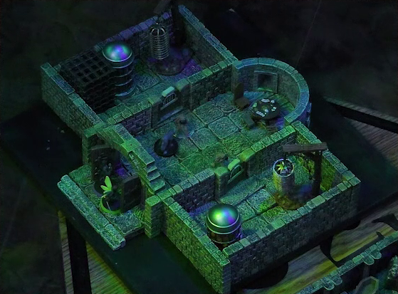 A battlemap of a stone aviary split into three rooms. Occtis and Thimble stand outside a closed door into the main chamber, in which are two ghouls and a circular table with a card game abandoned on it. Occtis’s undead monitor lizard faces off against the left ghoul. To the left of the main chamber is a closed door leading to a room with a large cubic black metal cage, a large cylindrical silvery metal cage, and a large cylindrical metal hanging cage resembling a bird cage. To the right of the main chamber is a closed door leading to a room with the same kind of silvery metal cage and hanging cage, although there is no large cubic cage.