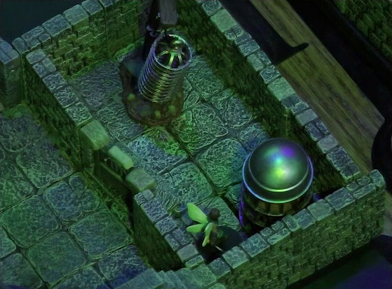 A battlemap of a stone aviary focused on a side room in which Thimble stands in front of a large cylindrical silvery metal cage. A large cylindrical metal hanging cage resembling a bird cage is also in the room. The door to the room is closed, and the edge of another chamber is visible through the door.
