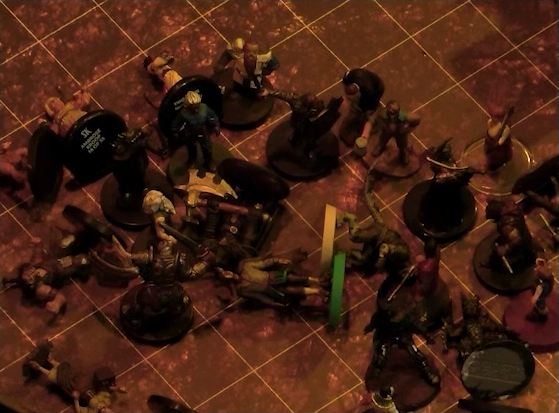 A battlemap focused on a group of black-armored soldiers, two of whom have fallen, facing off against Garen, Rei’nia, Fiedra, and a number of villagers. Erro, Crokas, and some other villagers have fallen as well.