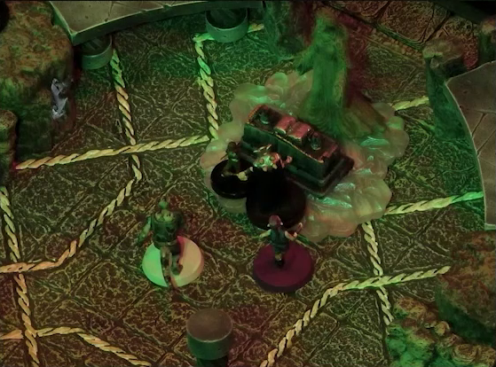 A battlemap of a stone temple interior focused on Lord Callister and Timothy standing before an altar and statue of the Moonweaver. Crokas and Fiedra approach them. The statue stands on a bed of white crystal.