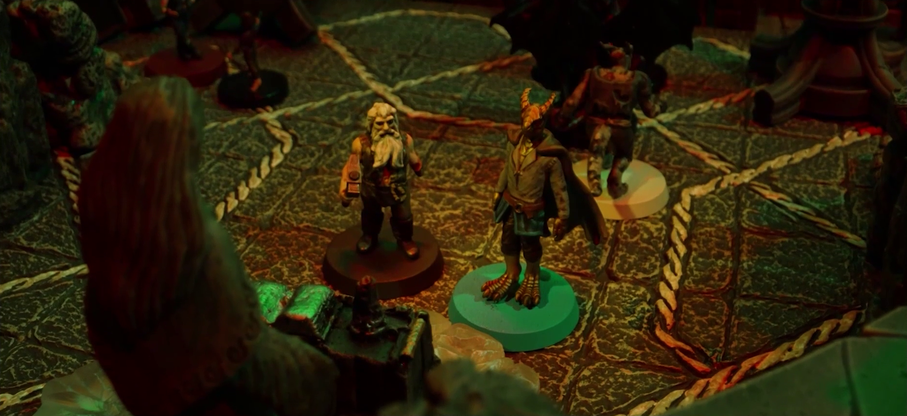 A battlemap of a stone temple interior focused on Garen and Erro standing before an altar and statue of the Moonweaver. Behind Erro is Crokas facing off against a dark devil with wide wings. A bit further back is Fiedra facing off against another devil.