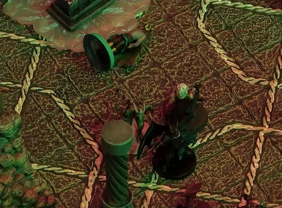 A battlemap of a stone temple interior focused on Garen facing off against two devils. Nearby is a fallen Erro, laying on the ground at the base of a statue of the Moonweaver.