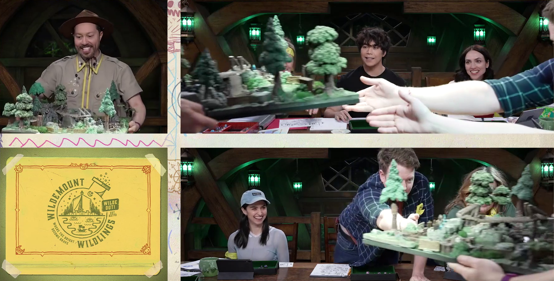 A three-camera shot including Sam carefully carrying a battlemap of a forest clearing with a bridge running down the center, and two other angles showing the players looking on as Brennan Lee Mulligan helps guide it down to the table. Aleks Le, Eden Riegel, and Libe Barer can be seen smiling, while Marisha and Ashley are mostly obscured by the battlemap. In the corner is the Wildemount Wildlings logo, a drawing of a lake-side campground inside a bubbling beaker surrounded by the text “WILDEMOUNT WILDLINGS. WILDE OUT! WHERE THE BRIGHT BECOME THE BRAVE. EST. 837PD”.