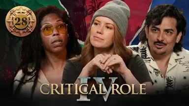 Thumbnail for Critical Role IV episode 28, with a gold emblem around the episode number. A split image having the effect of cracked plaster, with photos of Aabria, Marisha, and Robbie from left to right. The photos have had their backgrounds cut out, and behind them from left to right is artwork of a green-tinted stone bearded face, the red-tinted skyline of Dol-Makjar, and a blue-tinted misty city from a distance. Aabria has a shocked look on her face, mouth slightly open. Marisha looks thoughtful, clasping her hands in front of her and tilting her head to the side. Robbie is speaking, looking focused and confident.